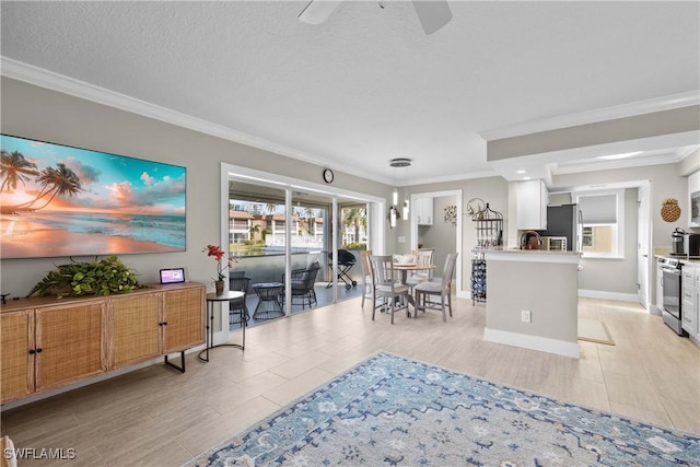 living room featuring light tile patterned floors, crown molding, a textured ceiling, and ceiling fan