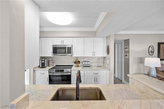 kitchen featuring white cabinetry, appliances with stainless steel finishes, sink, and crown molding