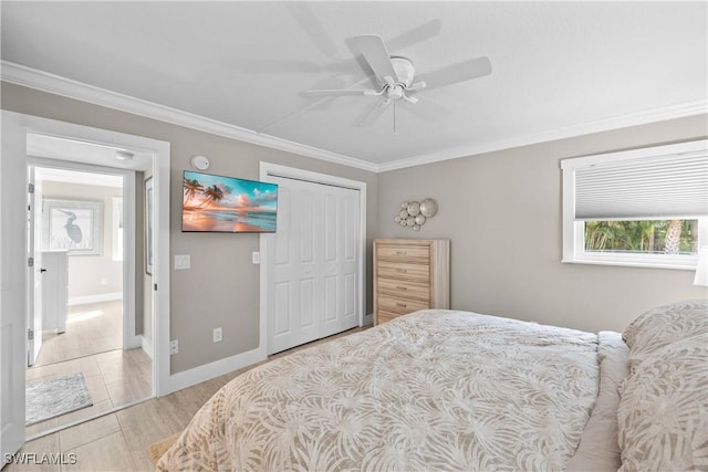 bedroom with crown molding, ceiling fan, and a closet