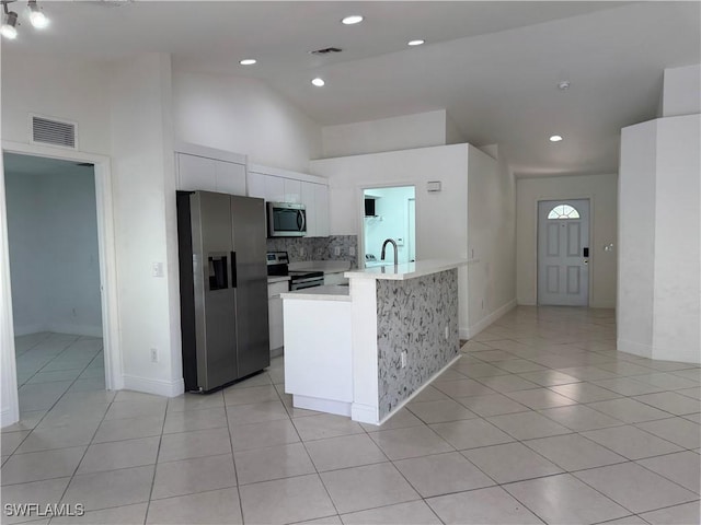 kitchen featuring light countertops, appliances with stainless steel finishes, light tile patterned flooring, and visible vents