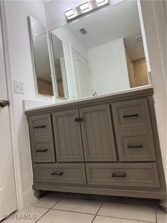 bathroom featuring visible vents, vanity, and tile patterned floors