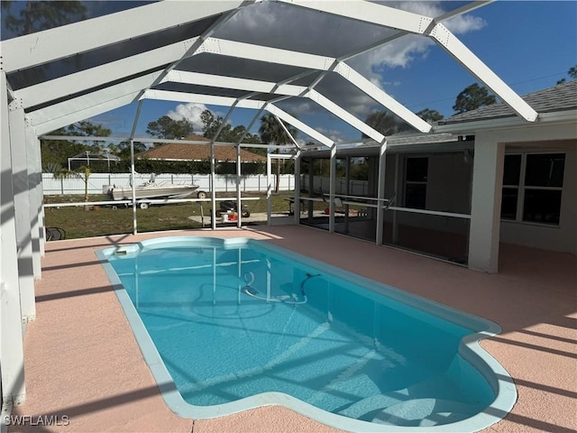 view of swimming pool with a lanai, a fenced backyard, a fenced in pool, and a patio