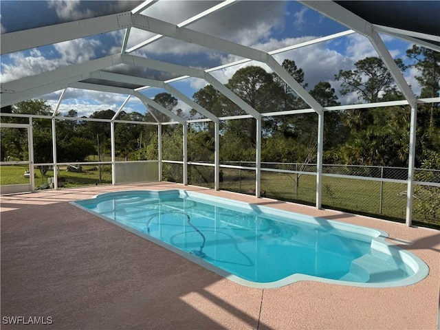 pool with a lanai, fence, and a patio