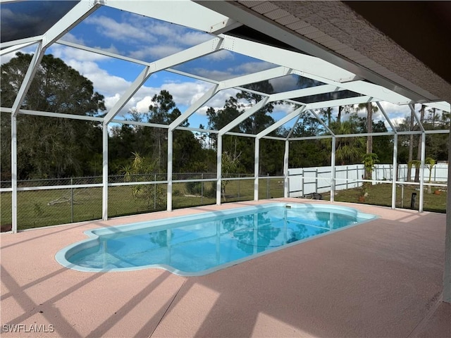 view of swimming pool with a fenced in pool, glass enclosure, a patio area, and fence