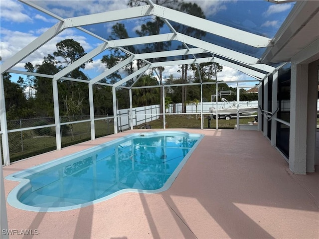 view of swimming pool with a fenced in pool, a lanai, a fenced backyard, and a patio