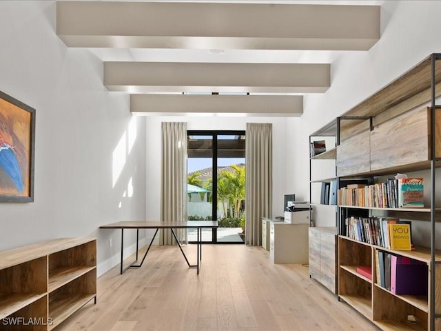 interior space with beam ceiling and light wood-type flooring