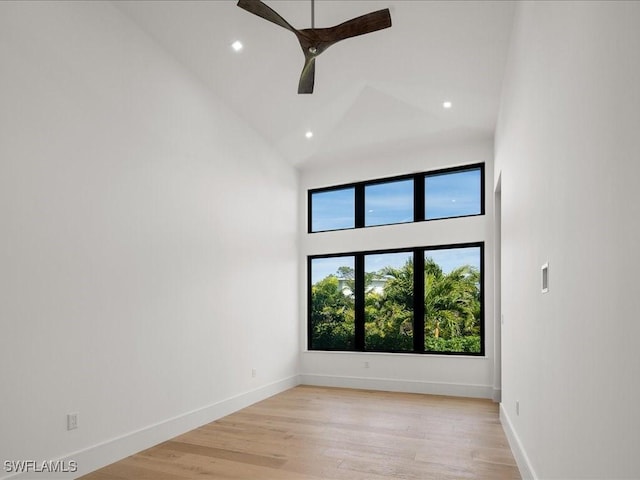 unfurnished room featuring ceiling fan, high vaulted ceiling, and light hardwood / wood-style flooring