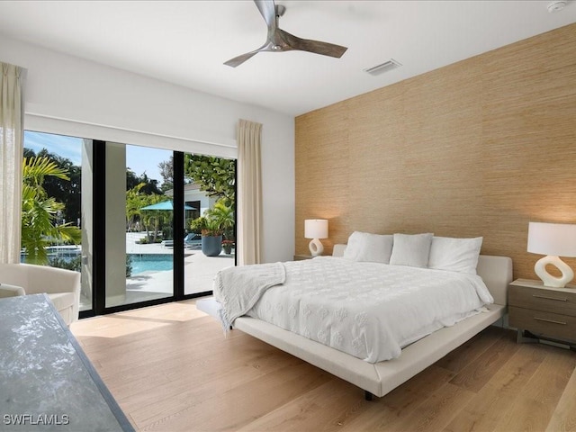 bedroom with light hardwood / wood-style flooring, access to outside, and ceiling fan