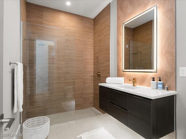 bathroom with vanity and a tile shower