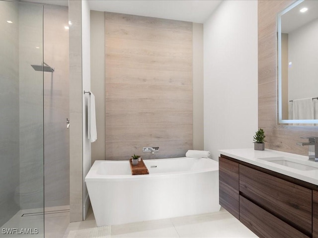 bathroom featuring vanity, tile patterned flooring, and plus walk in shower