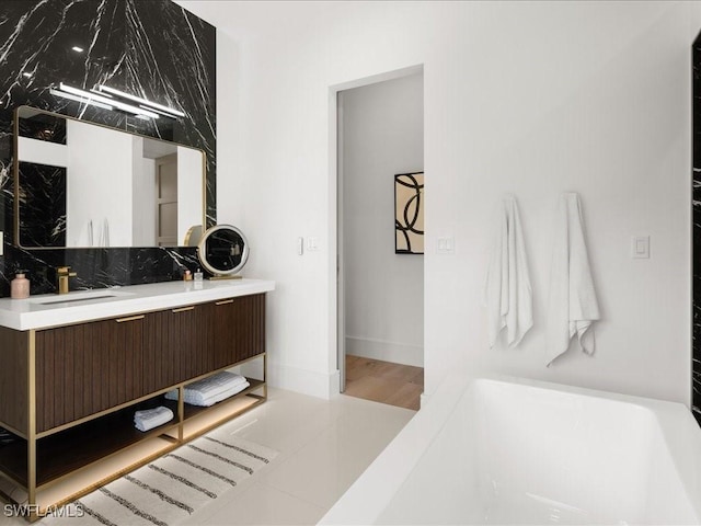 bathroom with tasteful backsplash and vanity