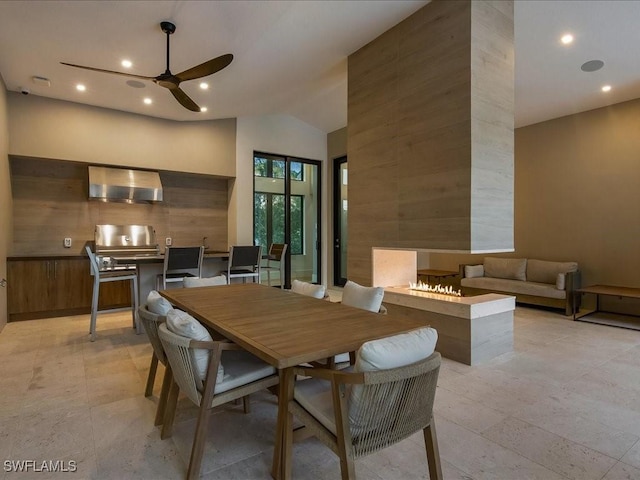 dining space featuring high vaulted ceiling and ceiling fan