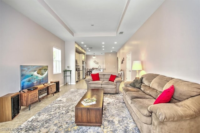 living room featuring a raised ceiling