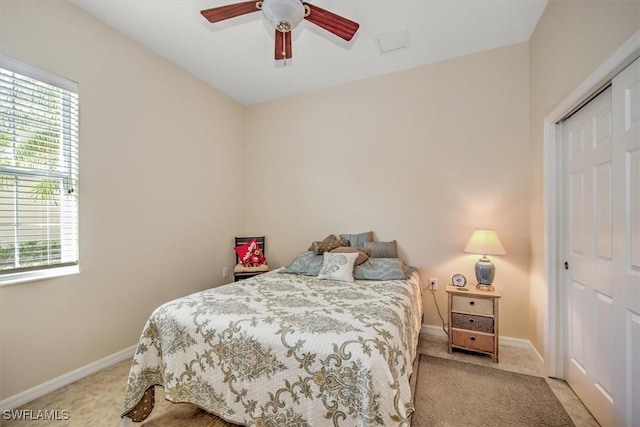 carpeted bedroom featuring a closet and ceiling fan