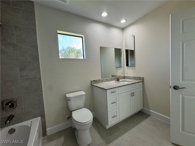 bathroom with vanity, toilet, and tile patterned flooring