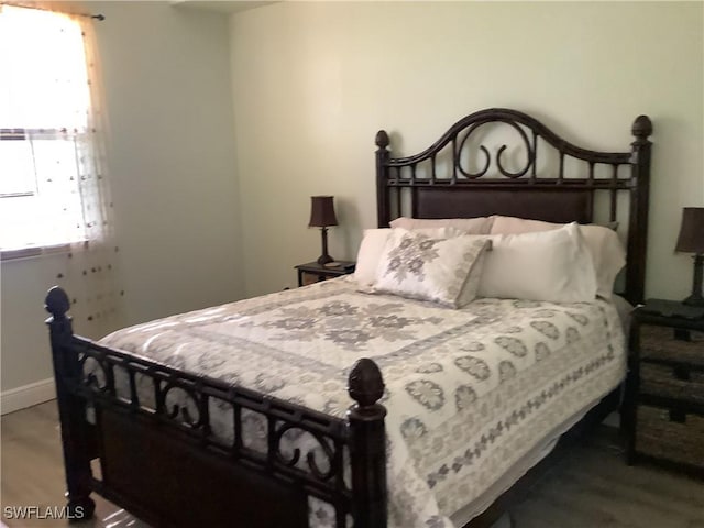 bedroom with hardwood / wood-style floors