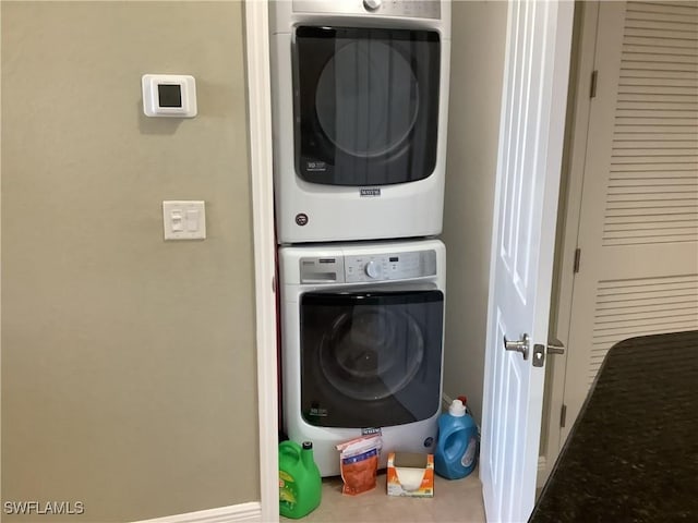 washroom featuring stacked washer / drying machine