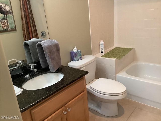 bathroom featuring vanity, tile patterned floors, and toilet