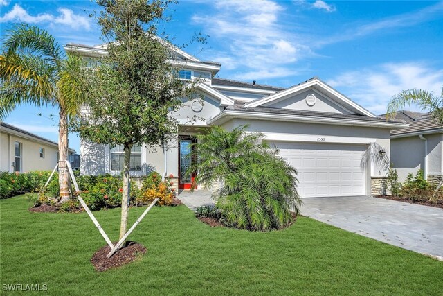 view of front of home with a garage and a front yard