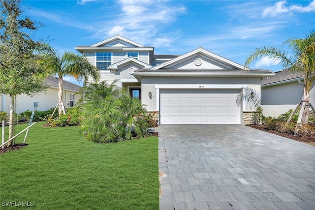 2553 Kona Way, Naples, FL 34120 - view of front facade with decorative driveway, a front lawn, an attached garage, stucco siding, and stone siding