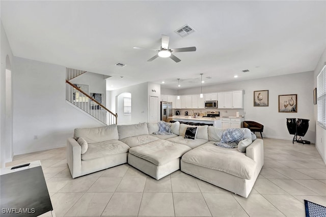 living room featuring ceiling fan and light tile patterned flooring