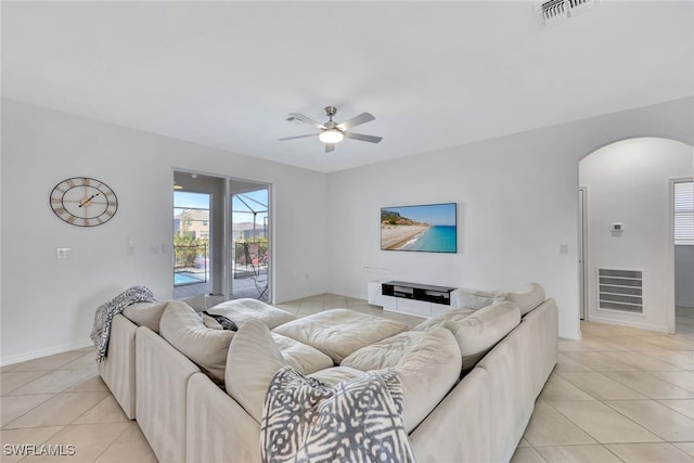 tiled living room featuring ceiling fan