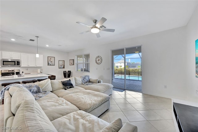 tiled living room with ceiling fan