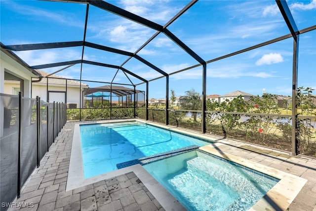 view of swimming pool featuring a patio area, an in ground hot tub, and glass enclosure