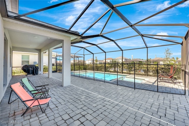 view of pool featuring grilling area, a lanai, and a patio area