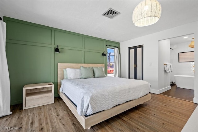 bedroom with hardwood / wood-style flooring