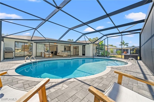 view of pool featuring area for grilling, a lanai, and a patio