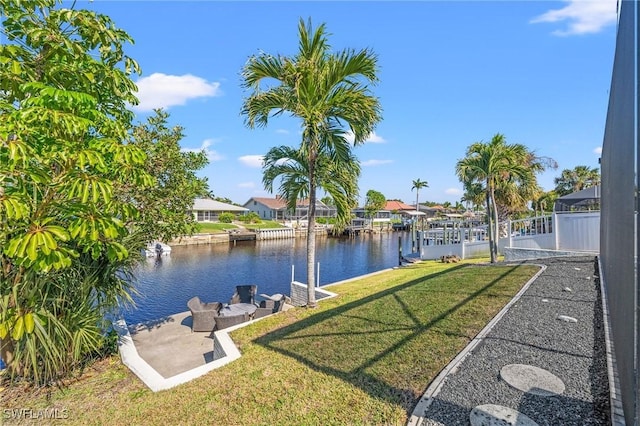 exterior space with a water view and a lawn