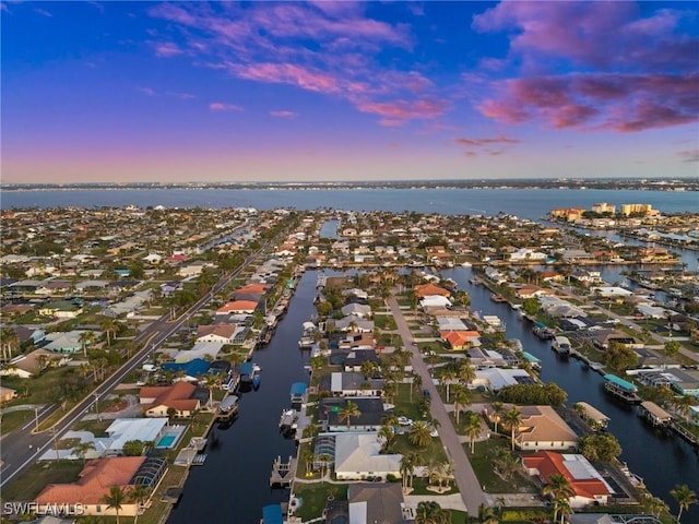 aerial view at dusk with a water view