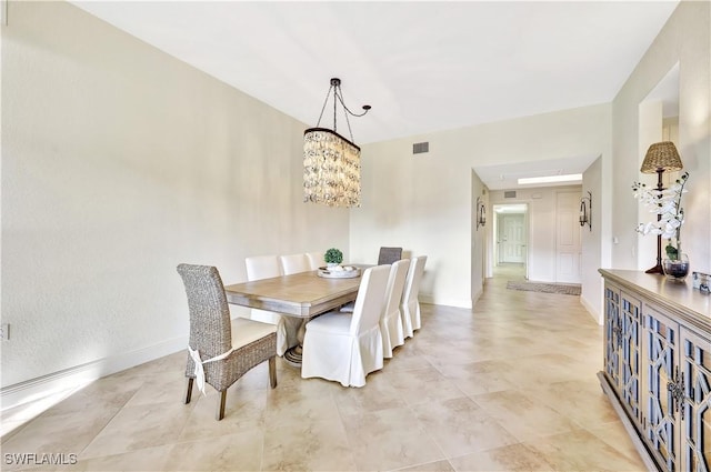 dining area featuring an inviting chandelier