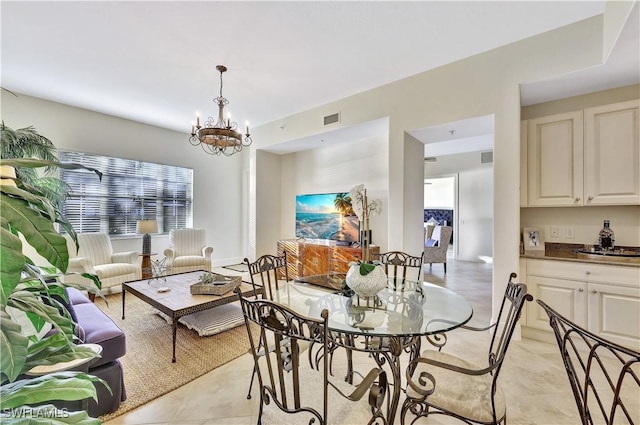 dining space with an inviting chandelier and light tile patterned floors