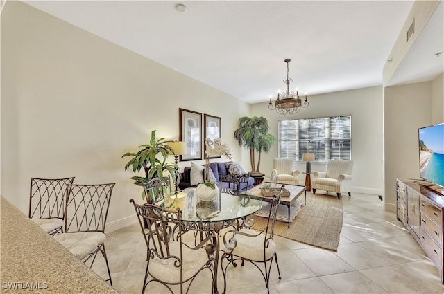 dining room featuring light tile patterned flooring and a chandelier