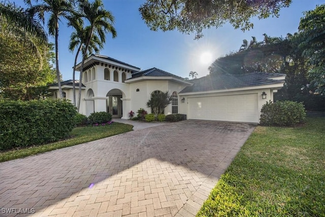 view of front of house with a garage and a front lawn