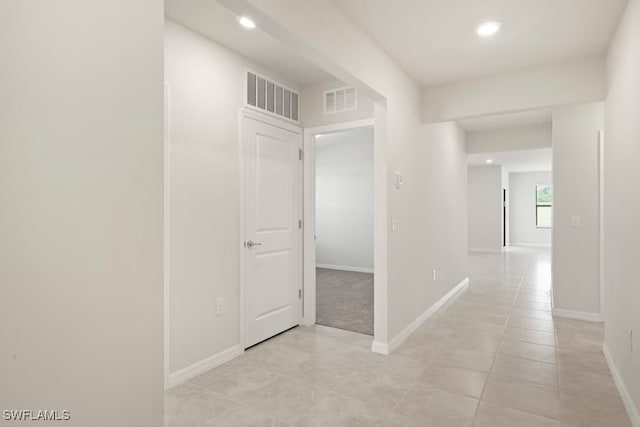 hall featuring light tile patterned floors