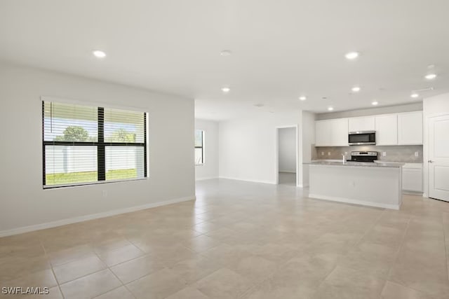 unfurnished living room featuring light tile patterned flooring