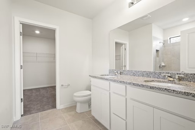 bathroom with vanity, toilet, tile patterned floors, and walk in shower