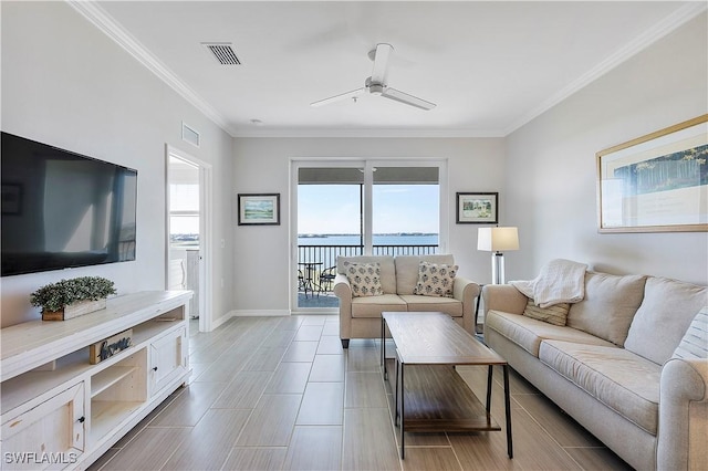 living room with crown molding, a water view, and ceiling fan