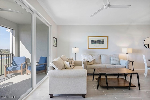 living room with ornamental molding and ceiling fan