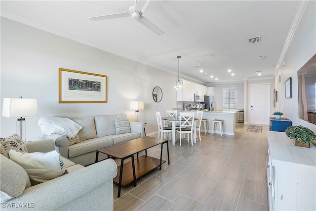 living room featuring ceiling fan and ornamental molding