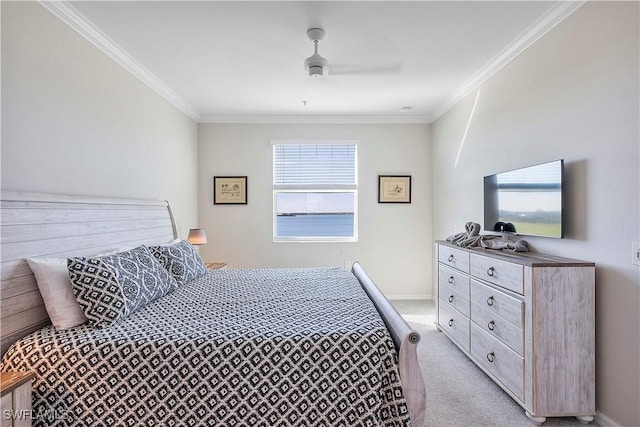 carpeted bedroom featuring crown molding and ceiling fan