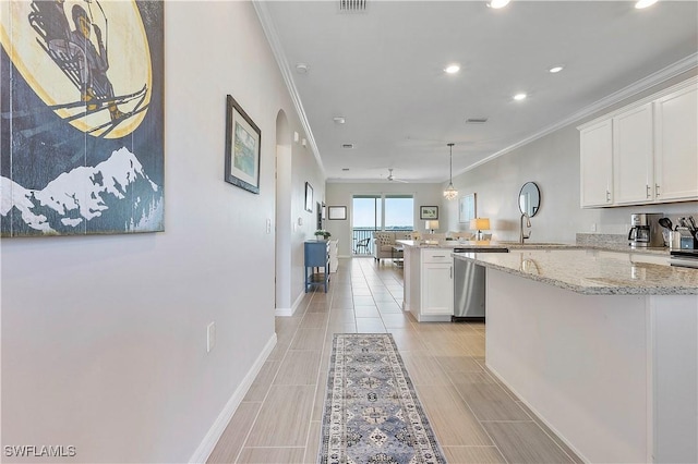 43010 Greenway Blvd Unit 244, Punta Gorda, FL 33982 - kitchen with a peninsula, crown molding, white cabinets, dishwasher, and light stone countertops
