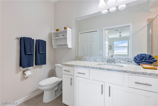 43010 Greenway Blvd Unit 244, Punta Gorda, FL 33982 - bathroom featuring toilet, baseboards, and vanity