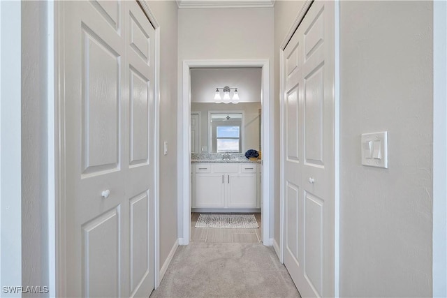 hallway featuring light colored carpet