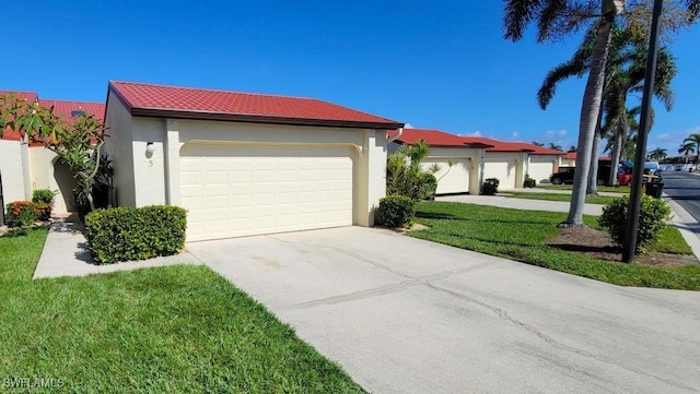 view of front of home with a garage and a front yard