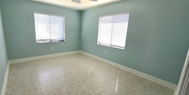 tiled empty room with ceiling fan