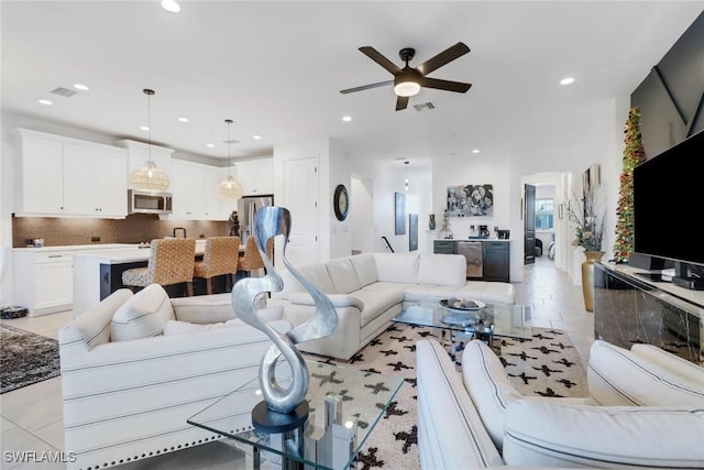 tiled living room featuring ceiling fan